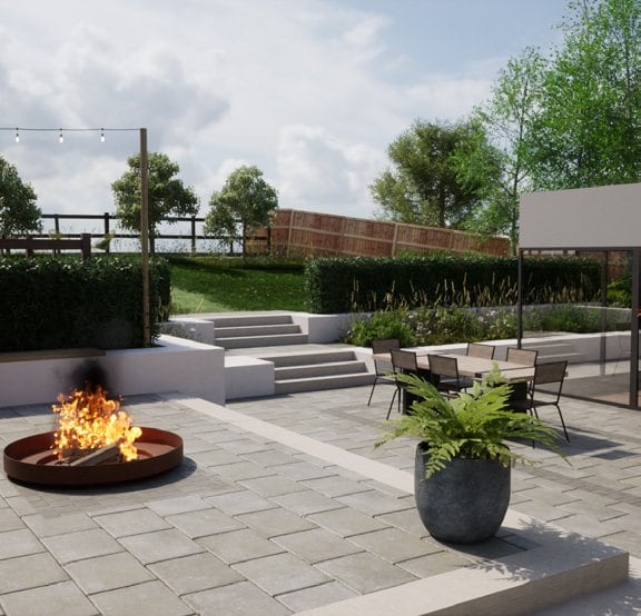 Paved terrace with a fire pit, low hedging and a raised lawn behind.