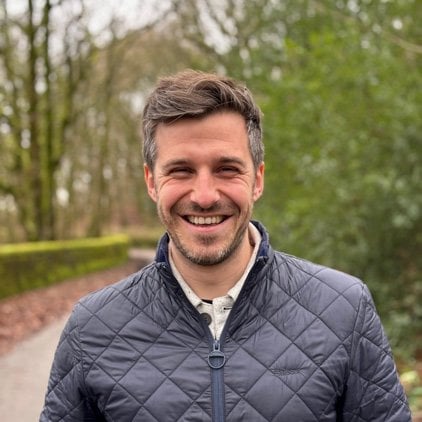 Portrait of Dan Charnley, Director of DAC Landscape Architecture, outdoors on a woodland path.